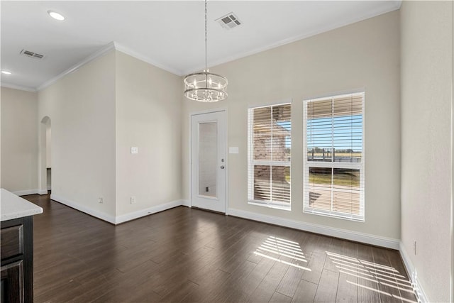 unfurnished dining area with ornamental molding, dark wood-type flooring, and a chandelier