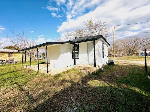 exterior space featuring cooling unit and a lawn