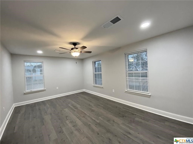 unfurnished room with ceiling fan and dark wood-type flooring