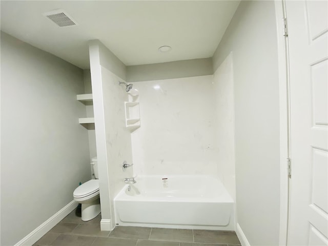 bathroom with toilet, tub / shower combination, and tile patterned flooring