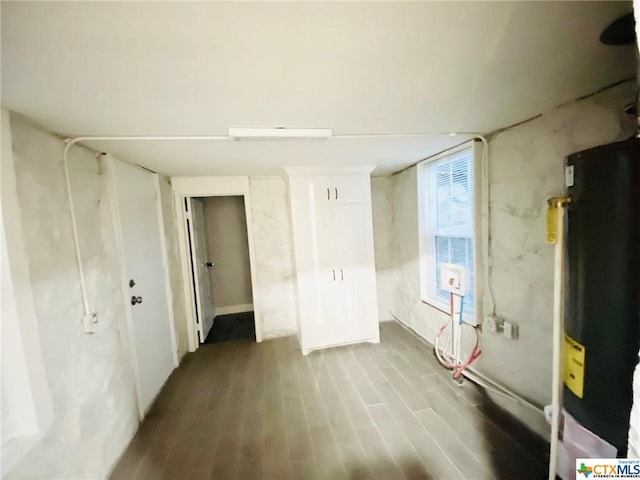 empty room with wood-type flooring and water heater