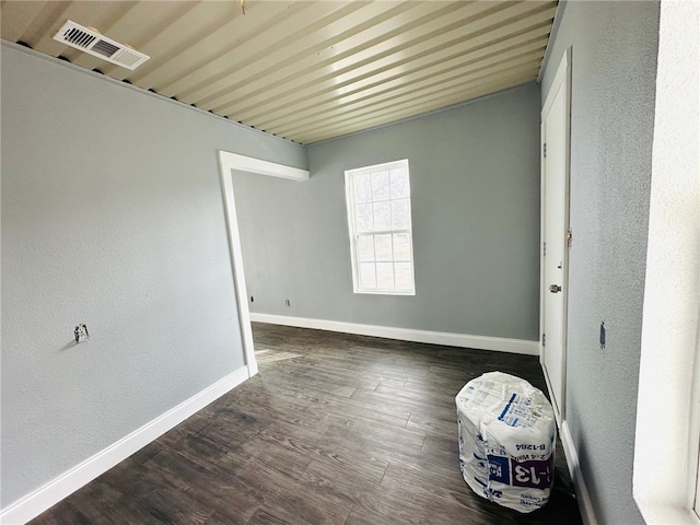 spare room featuring dark hardwood / wood-style floors