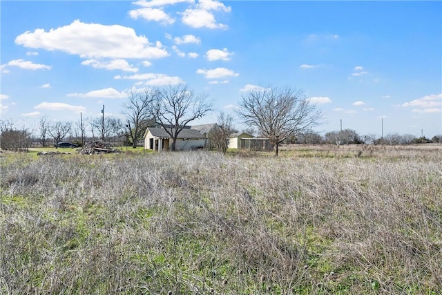 view of yard with a rural view