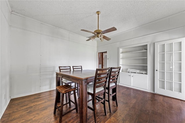 dining room featuring a ceiling fan, wood-type flooring, and a textured ceiling