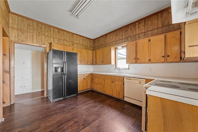 kitchen featuring white appliances, dark wood finished floors, light countertops, crown molding, and a sink