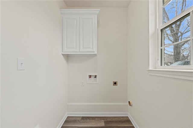 washroom featuring cabinet space, baseboards, washer hookup, and hookup for an electric dryer