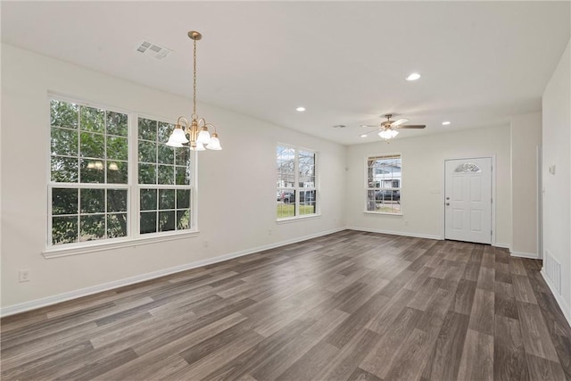 interior space featuring dark wood finished floors, recessed lighting, visible vents, baseboards, and ceiling fan with notable chandelier