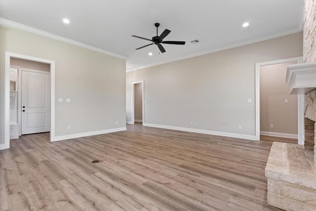 unfurnished living room with crown molding, a fireplace, ceiling fan, and light hardwood / wood-style flooring