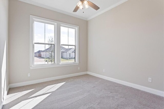 spare room featuring light carpet, ceiling fan, and ornamental molding