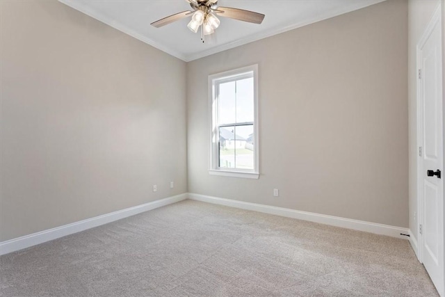 carpeted spare room with crown molding and ceiling fan