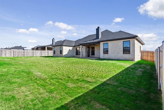 rear view of house featuring a lawn, ceiling fan, and a patio area