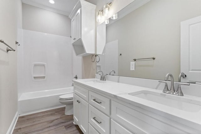 full bathroom with hardwood / wood-style floors, vanity, toilet, and shower / bathtub combination