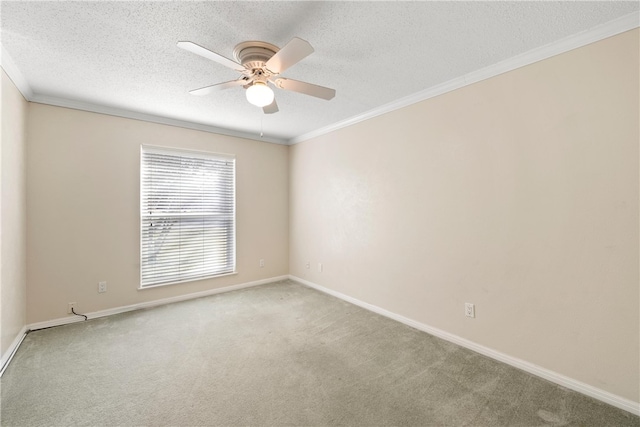 spare room featuring a textured ceiling, ceiling fan, light colored carpet, baseboards, and ornamental molding