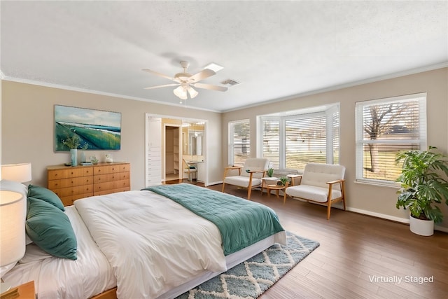 bedroom featuring baseboards, dark wood-style flooring, visible vents, and crown molding