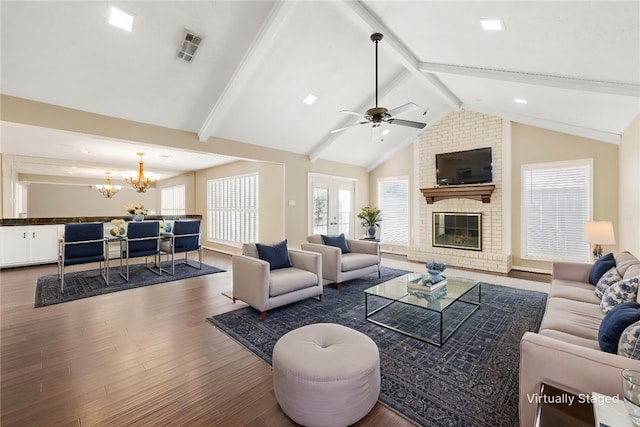 living room with visible vents, dark wood-style floors, vaulted ceiling with beams, french doors, and a brick fireplace