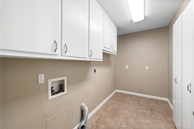 laundry area featuring a textured ceiling, washer hookup, baseboards, cabinet space, and electric dryer hookup