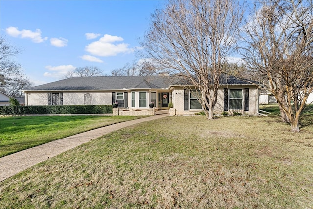 ranch-style home featuring a front yard and brick siding