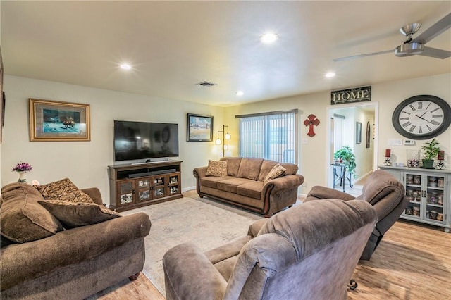 living room featuring a ceiling fan, visible vents, wood finished floors, and recessed lighting