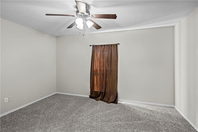 carpeted empty room featuring ceiling fan and a textured ceiling