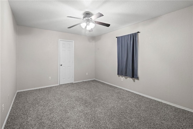 spare room featuring ceiling fan and carpet floors