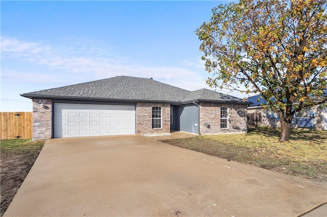 view of front of property featuring a garage and a front lawn