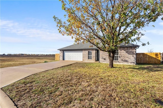 single story home with a rural view, a front yard, and a garage