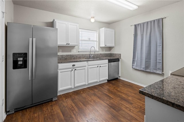 kitchen featuring white cabinetry, sink, dark wood-type flooring, and appliances with stainless steel finishes