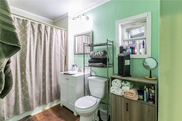 bathroom with curtained shower, wood-type flooring, ornamental molding, and toilet