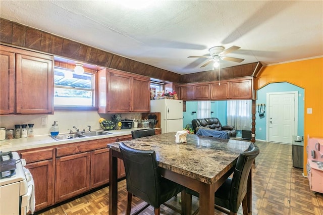 kitchen with ceiling fan, sink, parquet floors, and white appliances