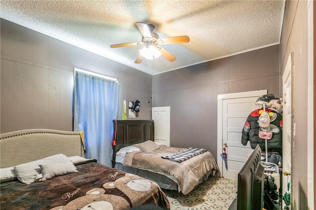 bedroom featuring ceiling fan, ornamental molding, and a textured ceiling