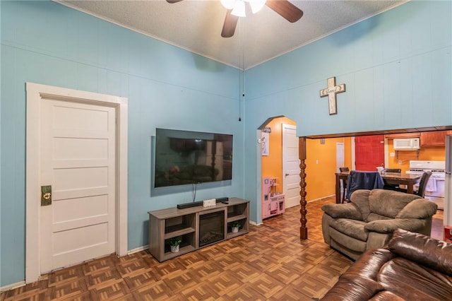 living room with a textured ceiling, dark parquet floors, and ceiling fan