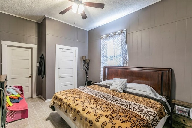 bedroom featuring crown molding, ceiling fan, and a textured ceiling