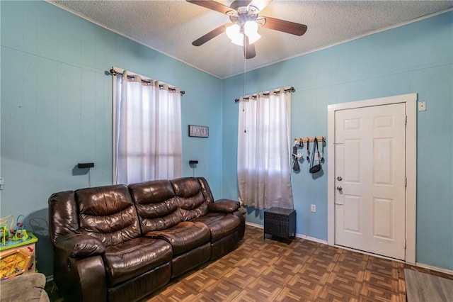 living room with ceiling fan, dark parquet floors, and a textured ceiling