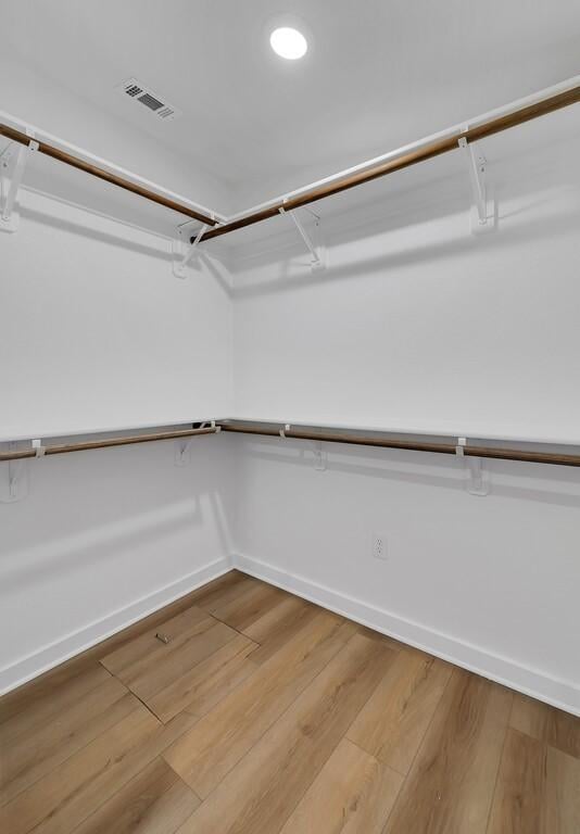 spacious closet featuring light wood-style flooring and visible vents