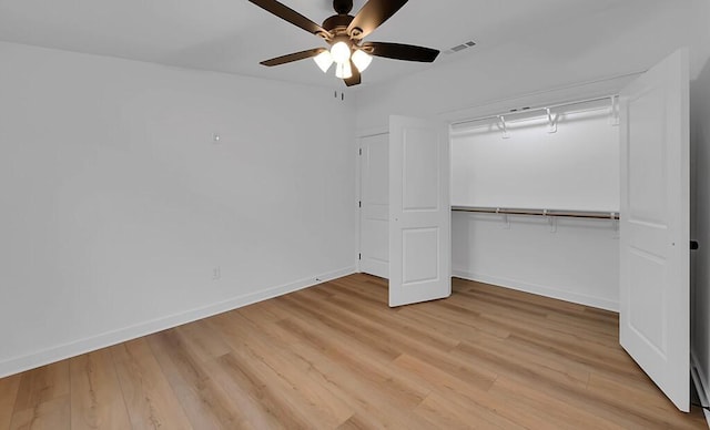 unfurnished bedroom with light wood-type flooring, visible vents, a closet, baseboards, and ceiling fan