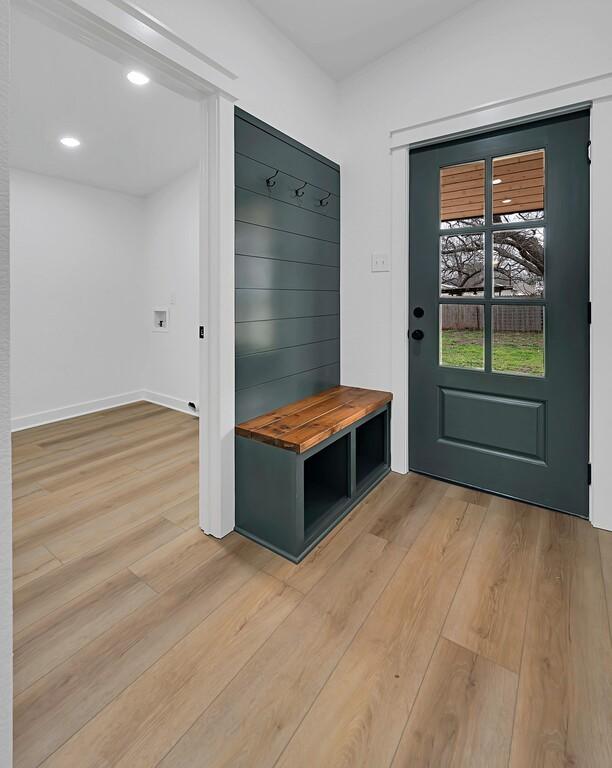 mudroom with baseboards and light wood-style flooring