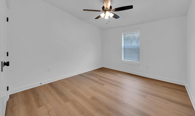 empty room featuring baseboards, light wood-style floors, and a ceiling fan