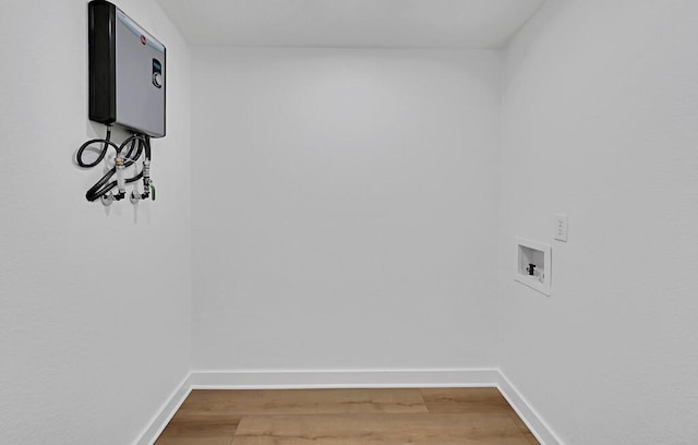 washroom featuring light wood-type flooring, baseboards, hookup for a washing machine, and laundry area