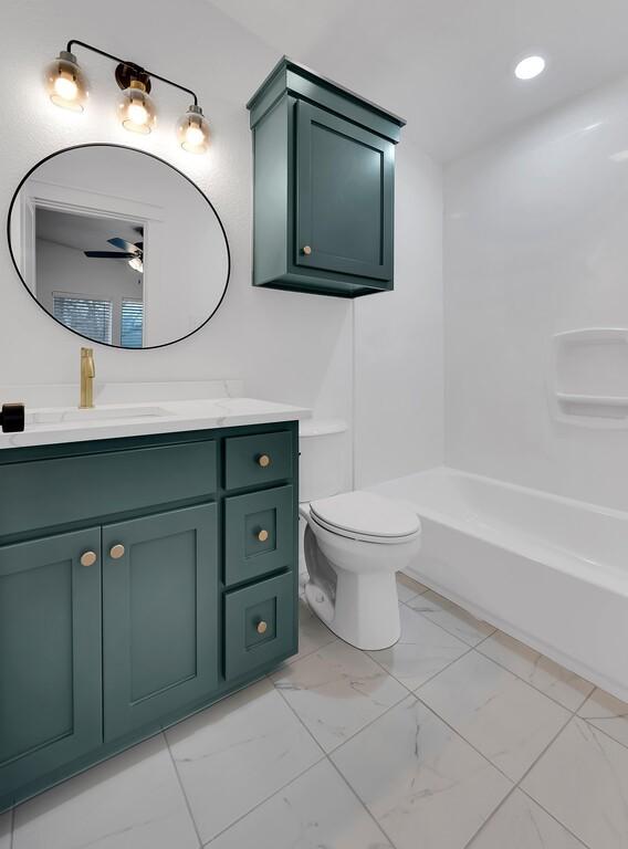 full bathroom with vanity, toilet, recessed lighting, and marble finish floor