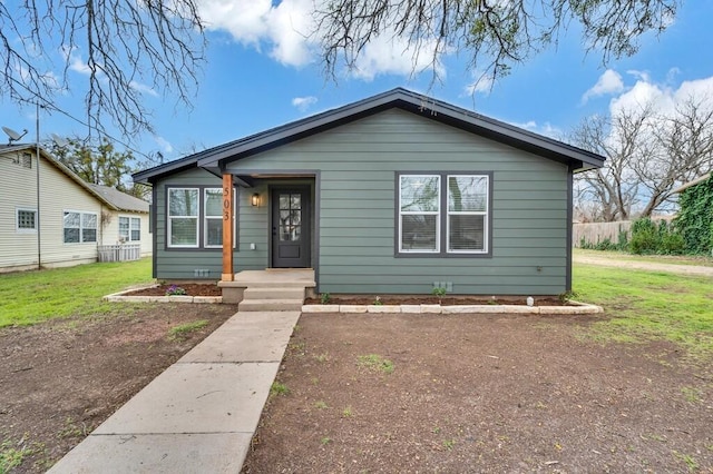 bungalow-style home featuring a front lawn