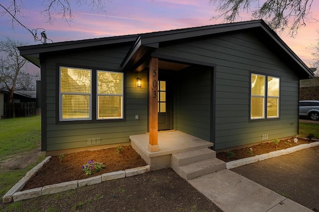 bungalow-style house featuring a yard