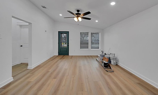 empty room featuring visible vents, baseboards, vaulted ceiling, recessed lighting, and light wood-style flooring