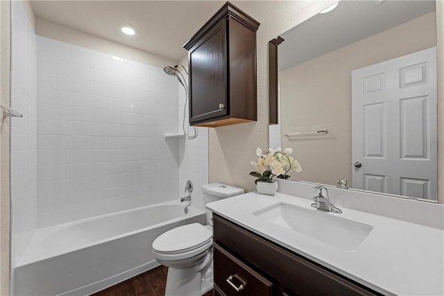 full bathroom featuring vanity, hardwood / wood-style flooring, bathing tub / shower combination, and toilet