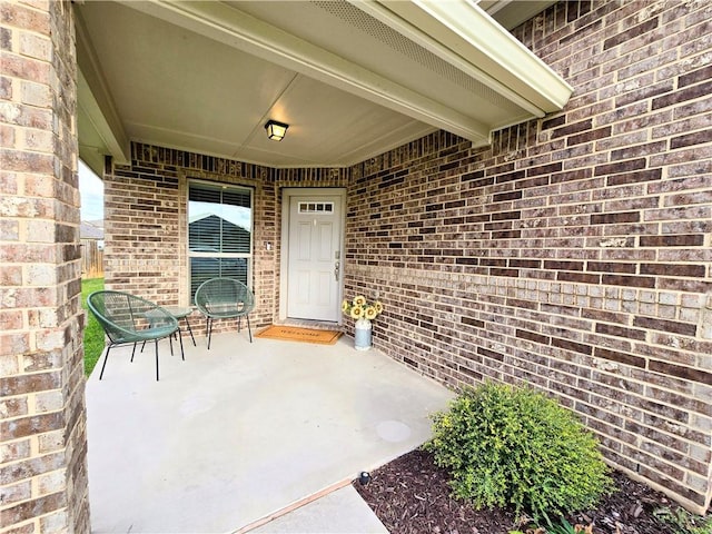 view of exterior entry featuring a patio area