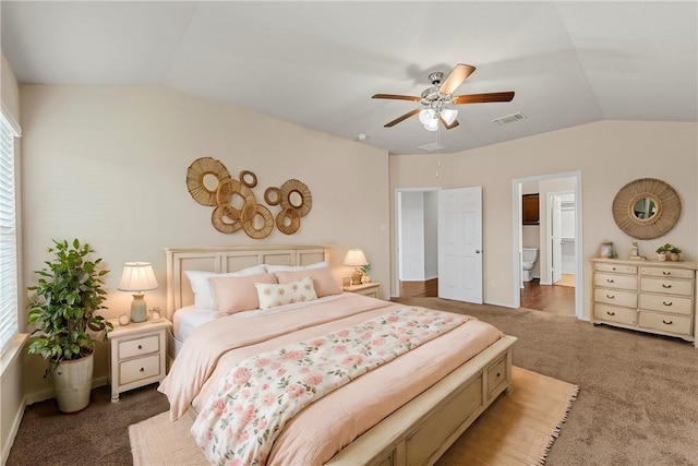 bedroom with lofted ceiling, ensuite bath, ceiling fan, and carpet flooring