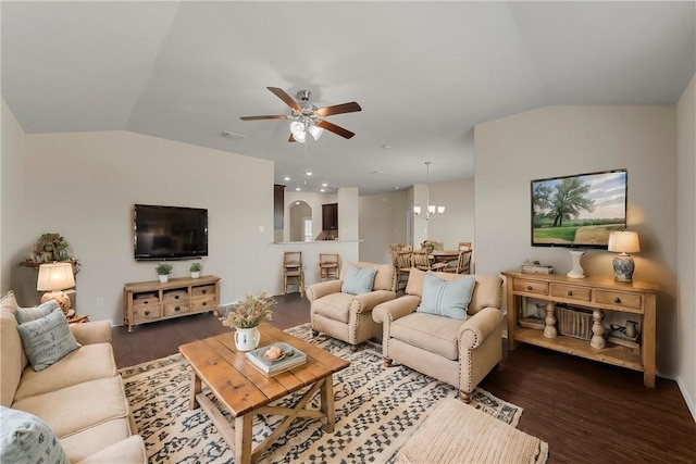 living room with vaulted ceiling, ceiling fan with notable chandelier, and dark hardwood / wood-style flooring