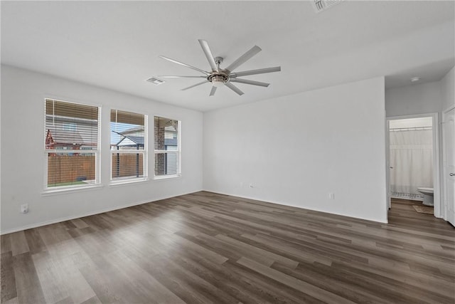 empty room featuring ceiling fan and dark wood-type flooring