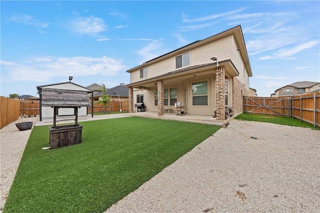 rear view of property with a patio area and a yard