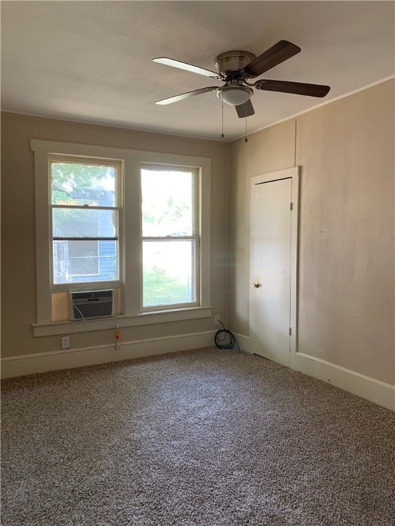 carpeted spare room with ceiling fan, cooling unit, and a wealth of natural light