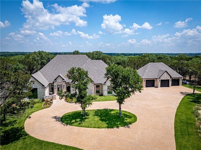 french country style house with a garage and a front yard